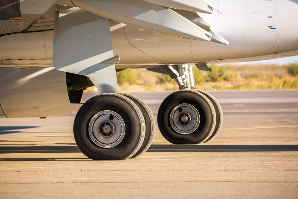 Wheels of an aircraft on the tarmac awaiting takeoff